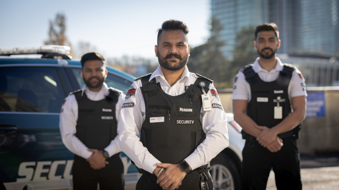 security guards in front of a security patrol car