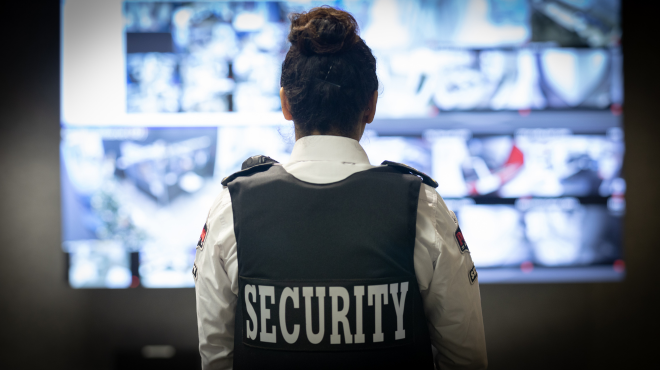 security guard surveying property over closed cameras