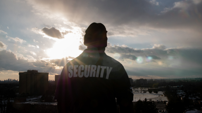 security guard overlooking the city at twilight