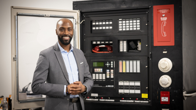 security director in front of a control panel