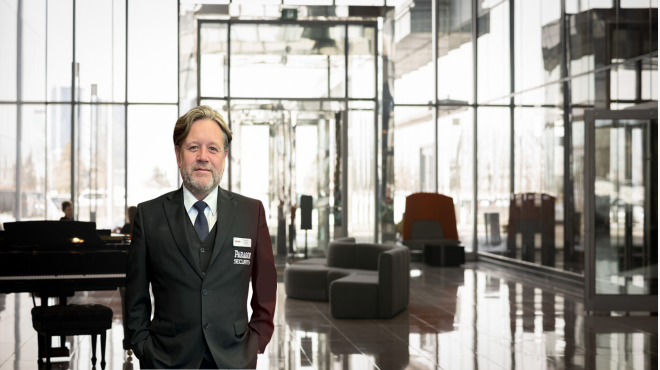 mature male security guard in the foyer of a luxury commercial building.